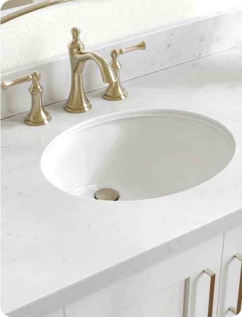 Countertops Close-up of a white quartz countertop with an undermount sink and black faucet set.